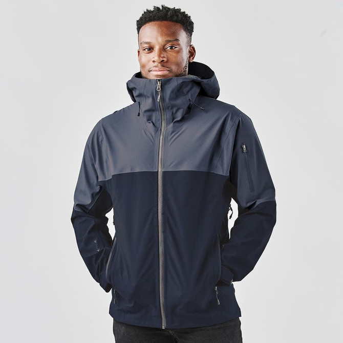 A rain jacket in navy and grey, featuring a hood and zippered front, with a logo on the sleeve.