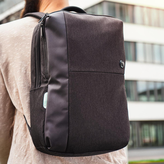 A black Swissdigital Arosa Backpack displayed on a model's back, featuring a sleek design and a logo.