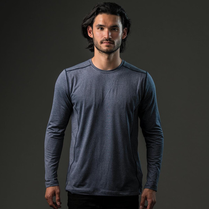 A long-sleeve grey t-shirt on a model, featuring a logo. The fabric appears lightweight and suitable for active wear.