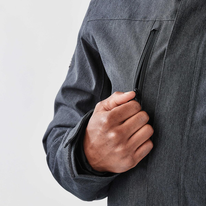 A men's jacket in dark grey with a zippered pocket and cuff detail, featuring a logo on the sleeve.