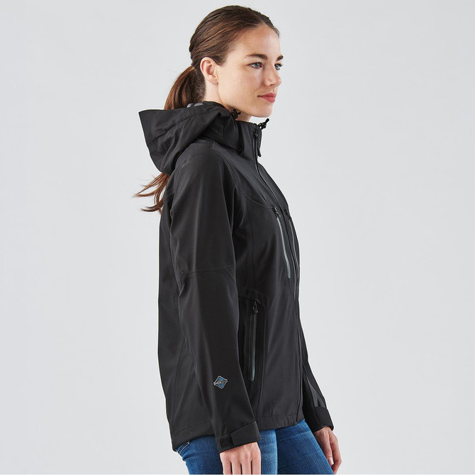 A women's black softshell jacket with a hood, featuring zippered pockets and a fitted silhouette.