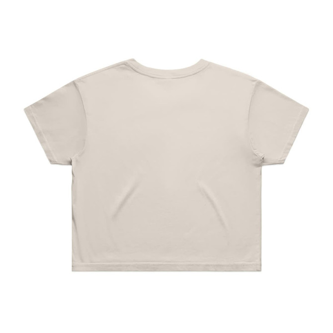 A beige crop tee with a simple design, featuring short sleeves and a slightly oversized fit. It has a logo.