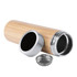 A drink bottle with a bamboo exterior, silver accents, and a removable strainer component.