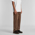 A pair of brown cord pants displayed on a model, featuring a relaxed fit and casual styling.