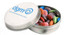 A silver tin containing colourful chocolate beans, featuring a simple logo on the lid.