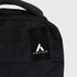 A black backpack with a textured surface and an attached tag featuring a logo.