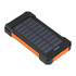A solar power bank in black and orange, featuring a textured surface and multiple charging indicators.