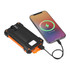 A solar power bank in black and orange connected to a smartphone, showing a charging status display.