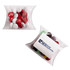 Mixed coloured choc beans in a clear pillow pack, featuring red, white, brown, and green candies.