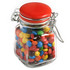 A glass clip lock jar with a red lid filled with colourful M&Ms in various shades. Comes with branding.