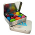 A rectangular silver tin filled with colourful jelly beans, featuring a branded logo on the lid.