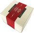 A small cream gift box with a red band contains mixed lollies, featuring a transparent window and a branded logo.
