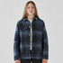 A plaid jacket in navy and blue tones with a Sherpa lining and snap buttons. Features two chest pockets and a logo.