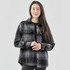 A women's shacket in grey and black plaid, featuring a collared design and two chest pockets.