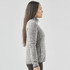 A side view of a women's grey full zip fleece jacket featuring a high collar and a branded logo.