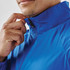 A blue full zip jacket with a high collar, featuring a person adjusting the zipper near the chin.
