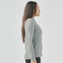 A women's long-sleeve polo shirt in grey, featuring a collar and a fitted design, with a visible logo.