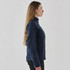 A women's softshell jacket in navy blue, featuring a high collar and side zipper pockets. It has a logo on it.