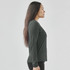 A long-sleeve women's t-shirt in dark green, displayed from the side with a fitted silhouette.