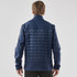 A navy blue men's softshell jacket with a quilted back and raised collar, featuring a logo on the upper left.