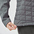 A grey women's thermal softshell jacket featuring a quilted design and a logo at the hem.