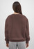 A brown women's crew sweatshirt with long sleeves and a relaxed fit, featuring a simple design and no visible branding.