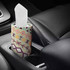 A patterned car bucket dry tissue holder in a car cup holder, featuring floral and geometric designs.