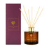 A reed diffuser in a brown glass bottle with golden accents, accompanied by a purple box.