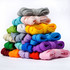 A stacked display of brightly coloured shoe laces in various shades, including pink, blue, green, and yellow.