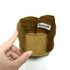 A small brown kraft paper storage bag with a decorative tag inside, being held by a hand.