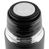 A drink bottle with a black exterior and a silver base, featuring an opening mechanism at the top and a logo.