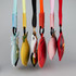 Five colourful bag charms hang from a display, featuring various designs like fruits and animals.