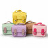 Mini Tech Charm Cases in yellow, green, pink, lavender, and brown stacked together, featuring heart designs and a logo.