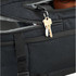 A black travel backpack featuring a keychain with keys inside a zippered compartment. The interior is grey.