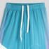 Custom youth active pants in gradient shades of blue with white drawstrings and a geometric pattern.