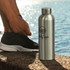 A drink bottle made of aluminium in a sleek black finish, featuring a silver cap and a rounded design.