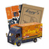 A small wooden model of a truck in blue and orange, with accompanying cardboard pieces for assembly.
