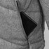 A grey puffer jacket featuring a zippered pocket with a smartphone partially visible. It has a subtle logo.