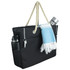 A black waterproof beach bag with a rope handle, featuring a drink bottle, a towel, and side pockets.