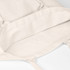 A beige tote bag with no gusset, featuring interior seams and soft fabric. It has a logo and long handles.