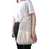 A person holding a cream-coloured mesh tote bag with a solid bottom and a textured upper section.