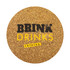 A round cork coaster with a textured golden surface and a logo in black and yellow.