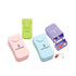 A set of three pill boxes in pink, green, and blue, featuring a logo and containing two capsules each.
