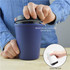 A reusable coffee cup in navy blue, featuring a reinforced silicone band seal and a leak-proof lid.
