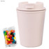 A drink bottle in pale pink with a lid, accompanied by a pack of colourful jelly beans.