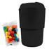 A reusable black coffee cup with a ribbed design beside a pack of colourful jelly beans, featuring a logo.
