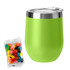 A green coffee mug with a stainless steel rim beside a bag of colourful jelly beans.