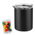 A black coffee mug with a transparent lid beside a pack of colourful jelly beans.