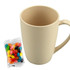 A bamboo mug in light beige next to a bag of colourful jelly beans, featuring a simple design and a handle.