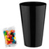 A black cup alongside a packet of colourful jelly beans in assorted hues. The cup is tall and cylindrical.